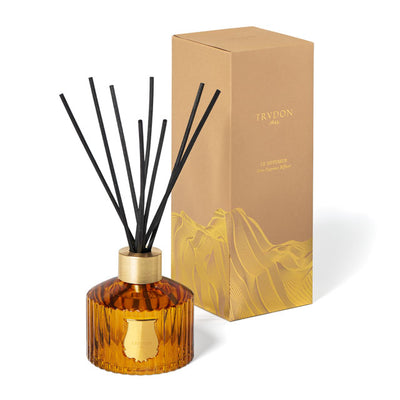 Trudon Altair luxury room diffuser in a signature fluted green glass bottle with gold-tone accents. Includes natural black reeds and a high-concentration oud and floral scent. Refillable designer home fragrance for stylish interiors.