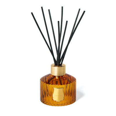 Trudon Altair luxury room diffuser in a signature fluted green glass bottle with gold-tone accents. Includes natural black reeds and a high-concentration oud and floral scent. Refillable designer home fragrance for stylish interiors.