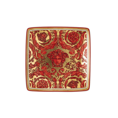 A luxury Versace Medusa Garland small porcelain bowl featuring a vibrant red finish, accented with an intricate gold acanthus leaf border and the iconic gold Medusa head emblem centered at the base.