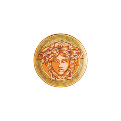Orange and gold coin with Versace Medusa head design on a white background for Lloyd and Paul Table Luxury